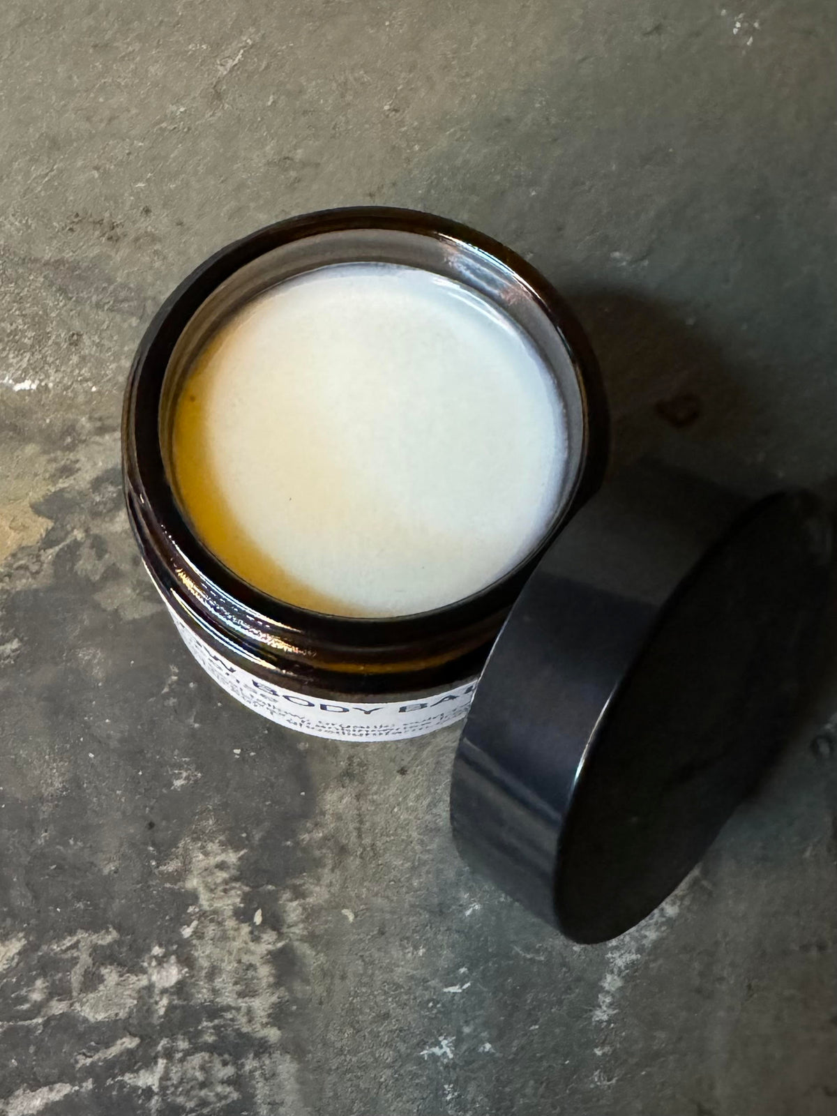 Open glass jar of tallow body balm made from pasture-raised beef tallow